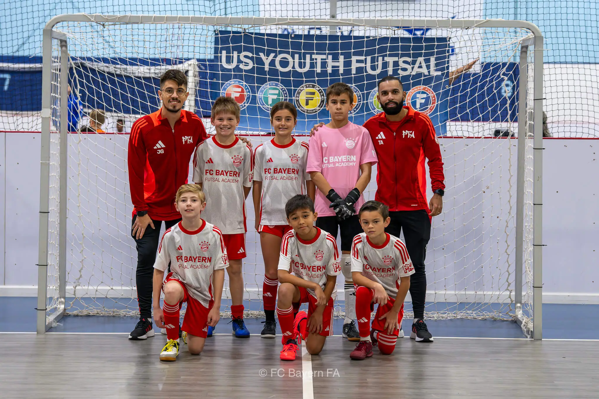 A group of kids from FC Bayern Futsal posing for a photo.