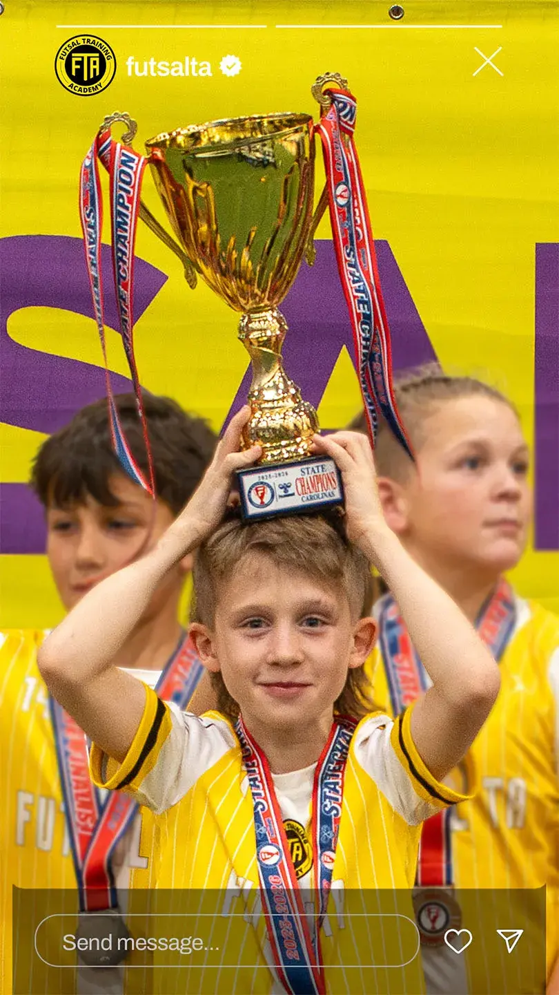 Player holding a futsal trophy over the head
