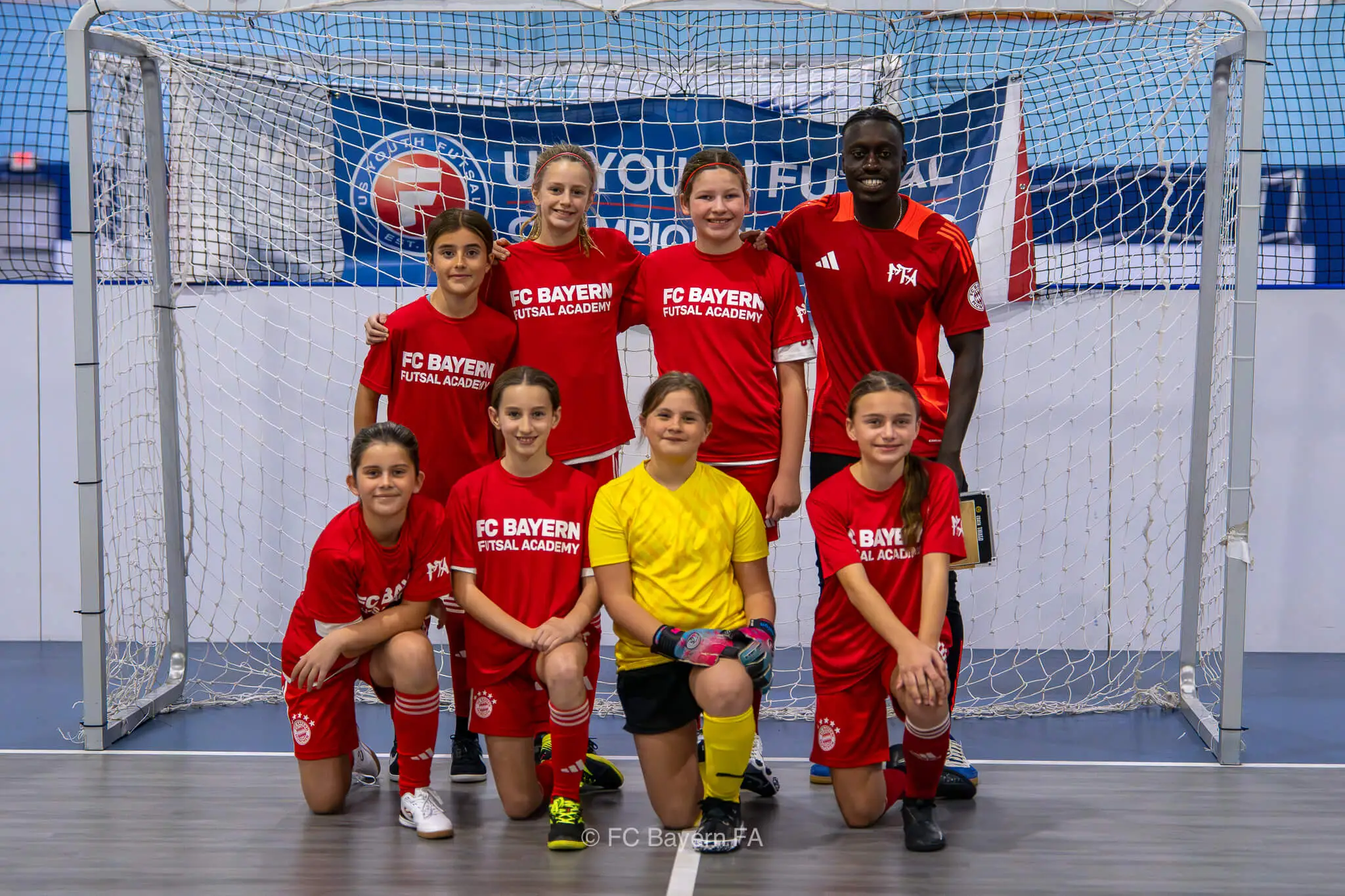 A group of kids from FC Bayern Futsal posing for a photo.