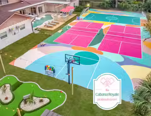 5,000 sq ft luxury 7-bedroom resort home in Clearwater, Florida featuring two full-size pickleball courts, heated pool with outdoor movie screen, custom mini golf course, basketball and futsal court, fire pit lounge, massive game room, and spacious accommodations for large groups just 10 minutes from Clearwater Beach.