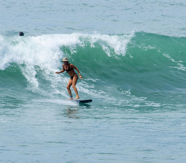 Surfer riding a wave during a surf lesson