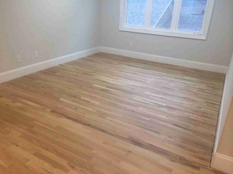 Close-up of a polished wooden floor showcasing rich grain patterns and warm tones.