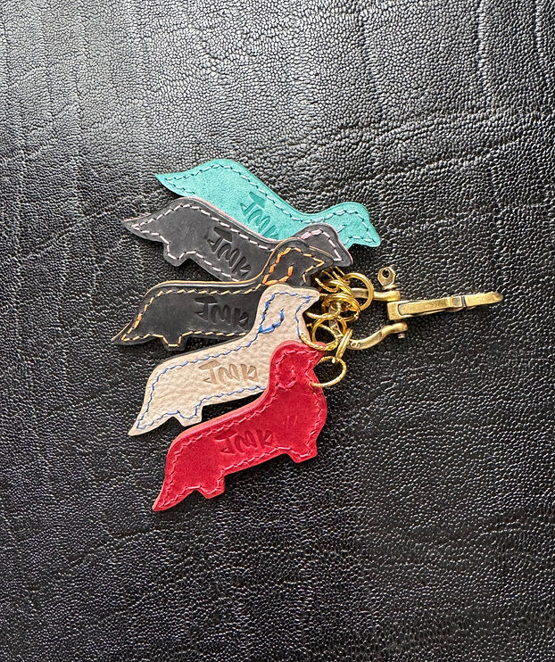 High quality genuine leather keychain, front angle in Bordeaux, Ivory, Black and Ice Blue colors