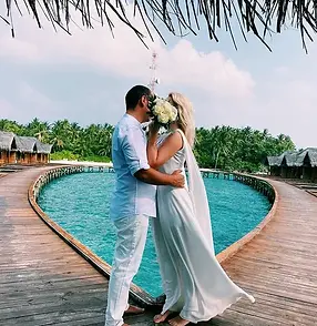 Couple dancing by a luxury pool with ocean view