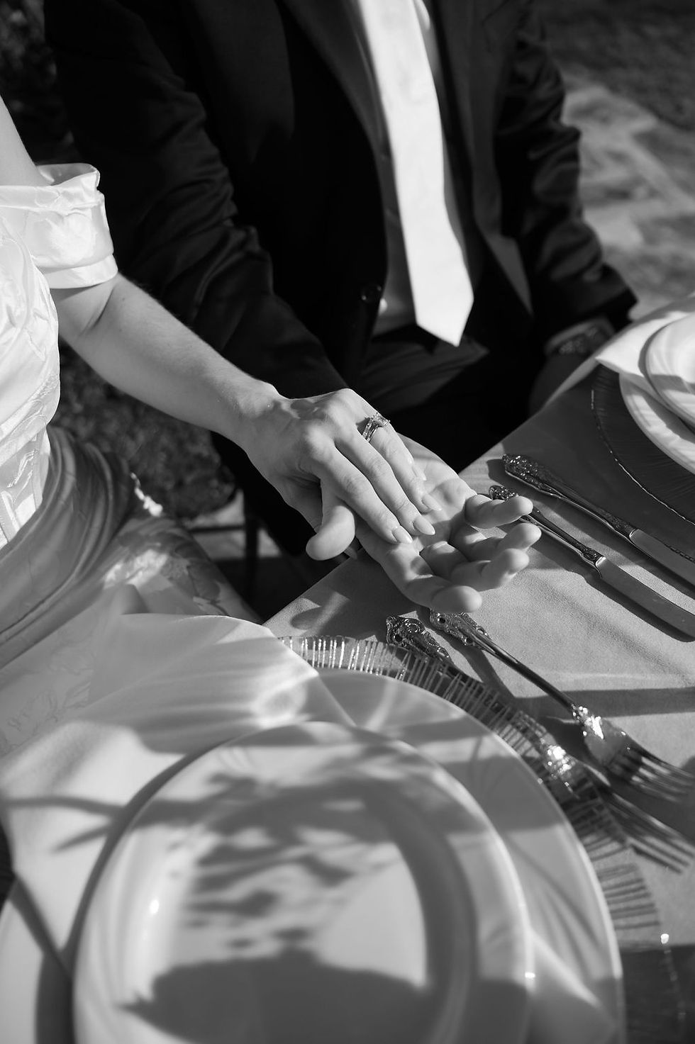 Couple holding hands at their wedding table