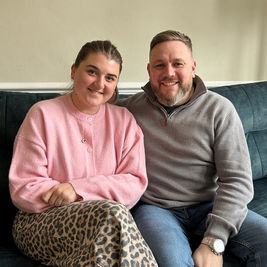 LINDA AND JONATHAN SEEN SAT ON A SOFA FIND FOSTER CARING EXTREMELY REWARDING | MAGE: LBH