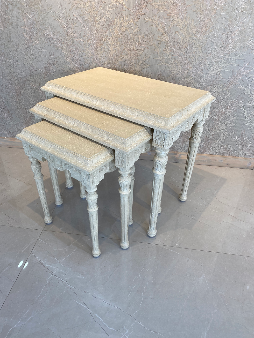 Ivory Carved Elegance Nesting Tables featuring intricate floral patterns and a smooth ivory finish, adding a touch of sophistication and charm to any living area.