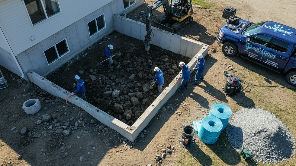 High angle view of workers excavating around a house foundation