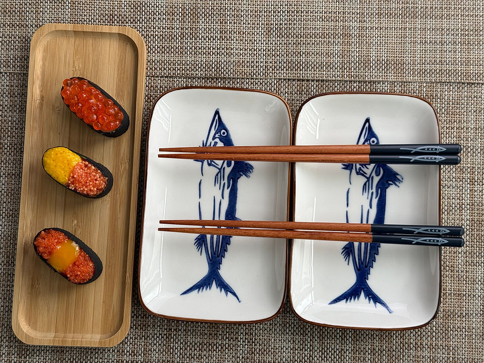 Thumbnail: White plate with sardin drawing and sushi pieces on it, chopstick next to the plate and sauce dish white with sardin drawing