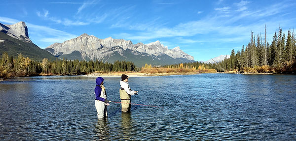 Nice couple standing in the Bow River casting lures