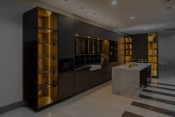 Modern kitchen interior featuring sleek cabinetry, stylish lighting, and a marble countertop, perfect for contemporary living.