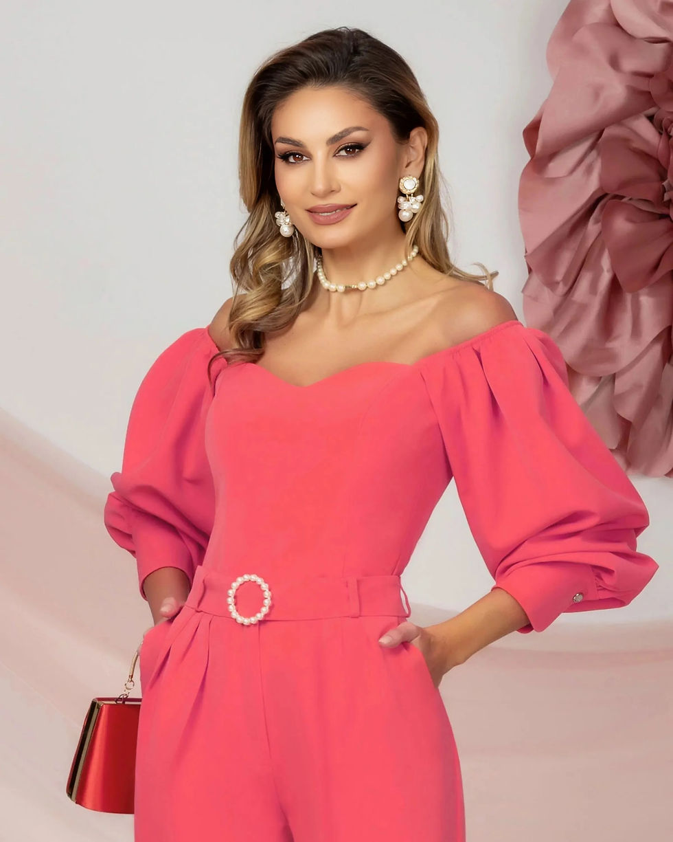 Thumbnail: Coral Tapered Trousers with Pleats at the Waist and Pearl Accessory