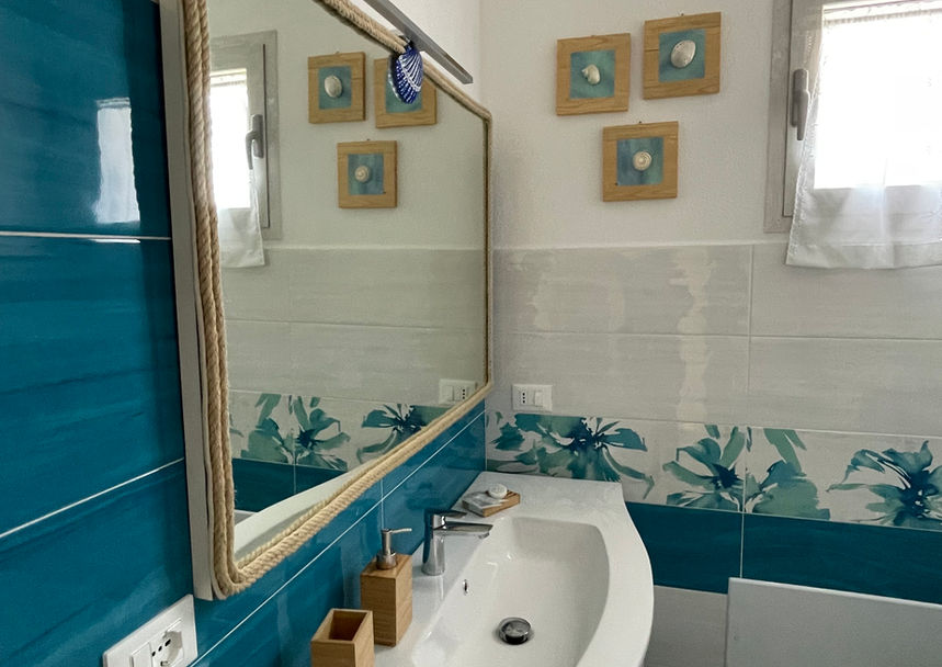 Modern and bright bathroom at Villa Agata, with blue accents and clean lines.
