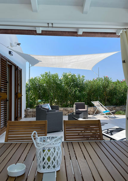 Cozy outdoor sofa and armchairs – perfect chill-out space by the pool