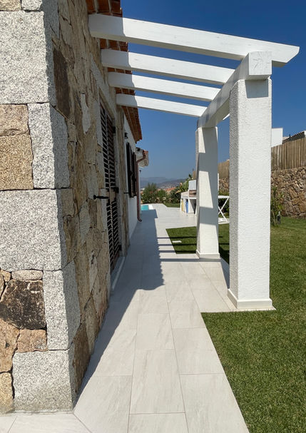 Shaded veranda with stone columns and tiled path – outdoor living at Villa Anna