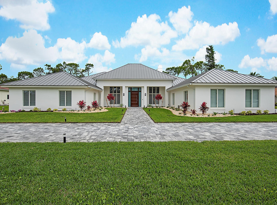 Luxury home addition and exterior renovation in Pelican Bay Naples FL by Ryan and Voigt Contracting — seamless guest suite addition with matched exterior finishes