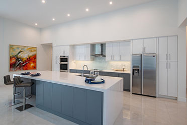 Bright kitchen renovation with white shaker cabinets and countertops