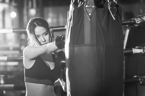 beautiful-female-punching-a-bag-with-box