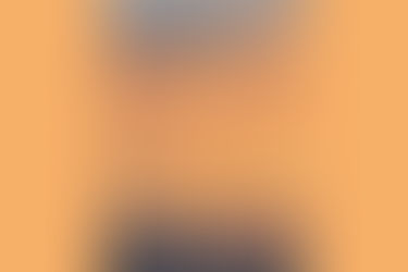 A yellow and orange sunset over mountains in the distance