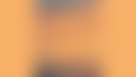 A yellow and orange sunset over mountains in the distance