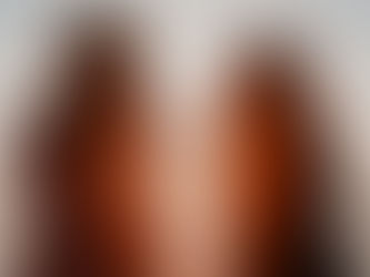 Two women with arms crossed and backs to the camera