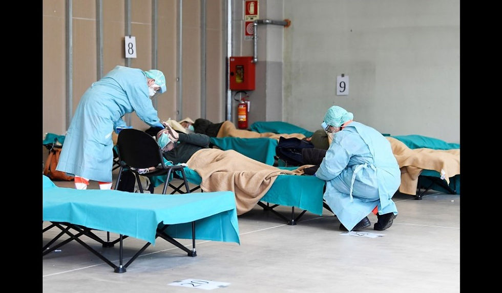 Hospital employees wearing protection masks as they attend to infected coronavirus patients at the Brescia hospital, Lombardy, on March 13, 2020, coronavirus, coronavirus patients, Italy, Europe, COVID-19