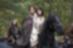 Caitriona Balfe, Sam Heughan, and Grant O'Rourke are depicted on horseback in a scenic Scottish highland setting from the Outlander series, photographed by Ed Miller for Sony Pictures Television.