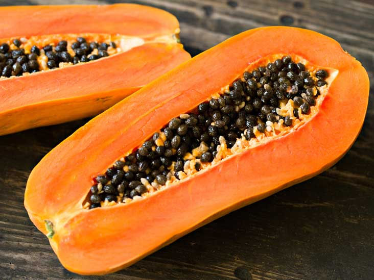 A picture of a fresh paw paw cut into two, papaya, paw paw, papaya seeds