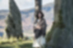 Claire Fraser stands atop Craigh na Dun, the ancient time-travel stones in Scotland, enveloped by the mystical aura of the rugged landscape. Photo by Ed Miller