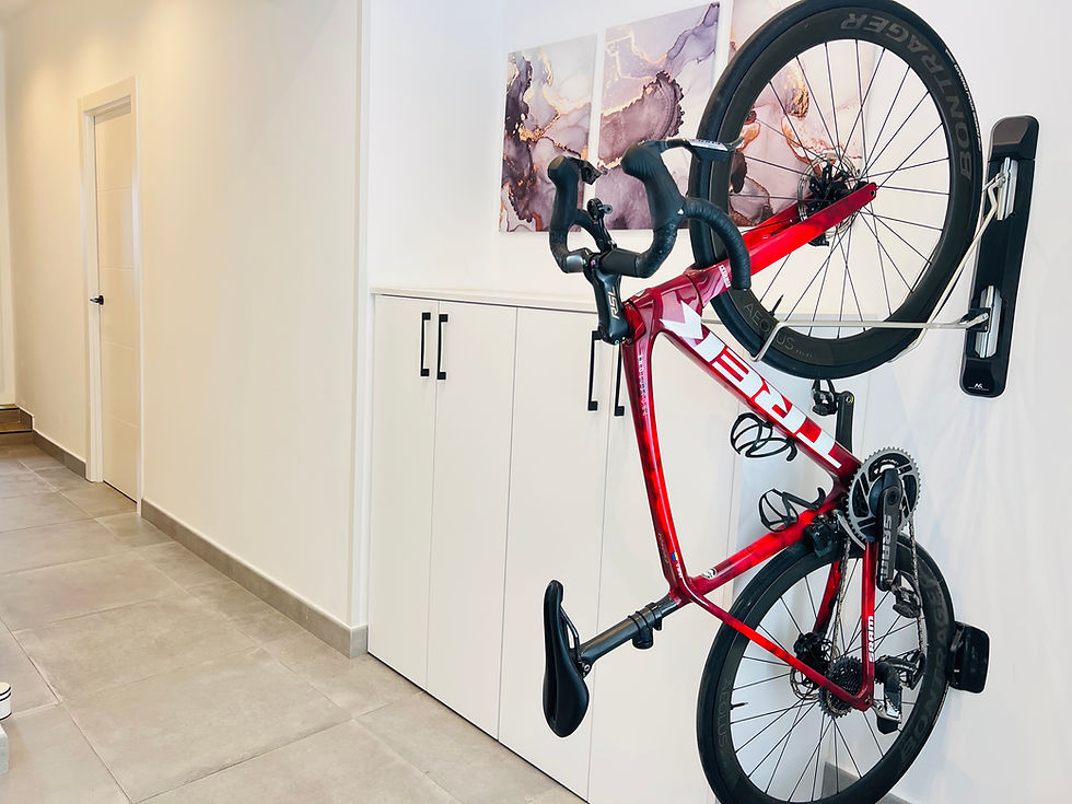 Road bike stored on a wall-mounted bike rack inside our holiday home in Ondara