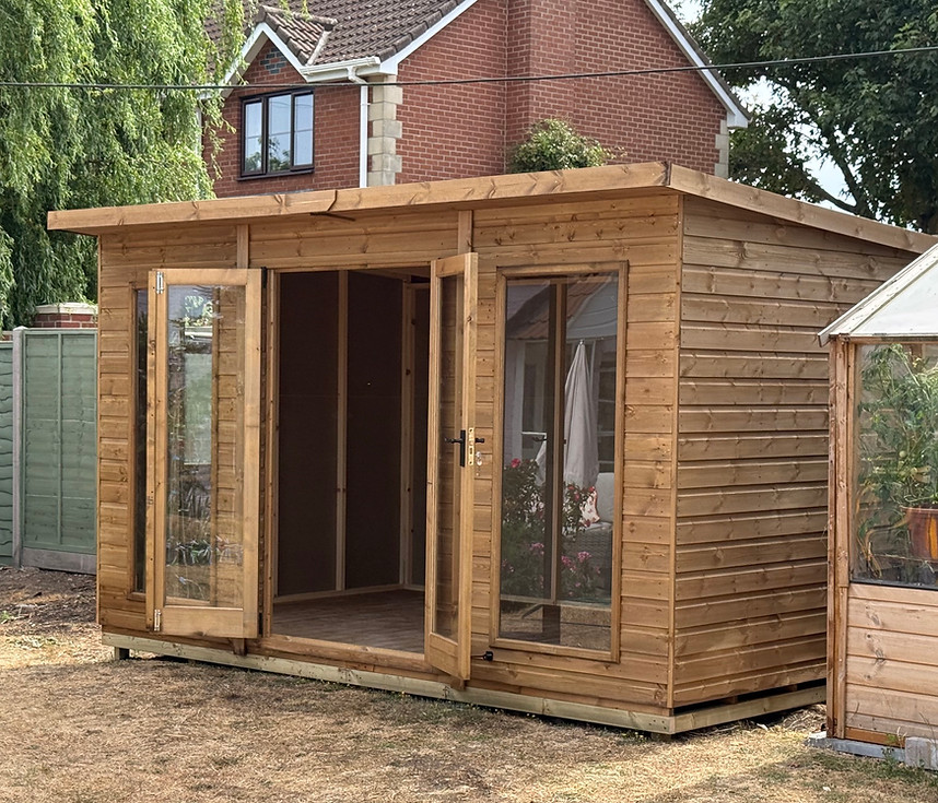 Wooden somerset summerhouses with double glass doors.