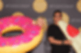 Couple in photo booth with inflatable donut and inflatable pizza photo prop