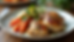 High angle view of a plated chicken dinner with roasted vegetables and lemon wedges