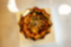 A close-up top view of a luxury amber crystal faucet handle featuring a star-shaped design, showcased at Crystal Home. The intricate facets and warm golden tones highlight THG Paris’ craftsmanship.