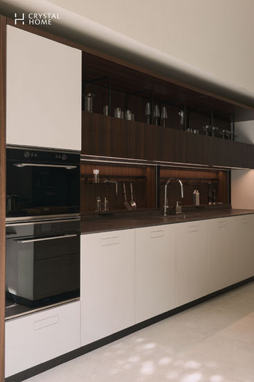 Built-in Composit kitchen in modern Italian style with white cabinetry and dark walnut shelving — blending elegance and sustainability.