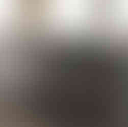 Marble-finished island kitchen with integrated sink and elegant accessories, set in a high-rise apartment.