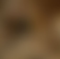 A couple enjoying a warm morning together in a modern built-in kitchen, preparing coffee and breakfast on a seamless stone countertop with wooden cabinetry and soft under-cabinet lighting. Crystal Home logo appears in the corner.