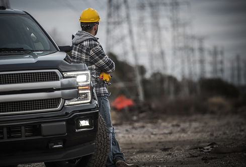 Caucasian Contractor Field Work Job. Worker and His Pickup Truck. Countryside Remote Locat