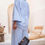 Thumbnail: Model in The Iris Pants holding small brown purse – soft resortwear look