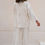 Thumbnail: Model wearing The Iris Pants in cream – button-down shirt and matching wide-leg pants