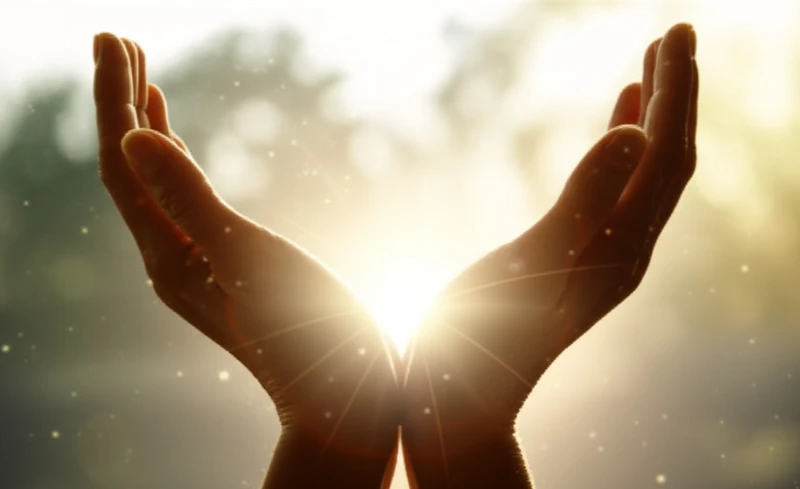 Hands open to light, symbolizing healing and spirituality. Healing Hands and Breath. Seeking positive energy.