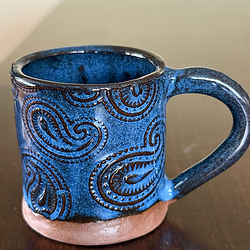 Espresso mug with glazed blue pattern on a wooden table