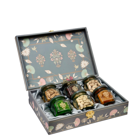 Assortment of dry fruits in a decorative box, Jagan Dryfruits GIFTING. Various nuts displayed.