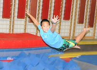Boy jumps into foam pit