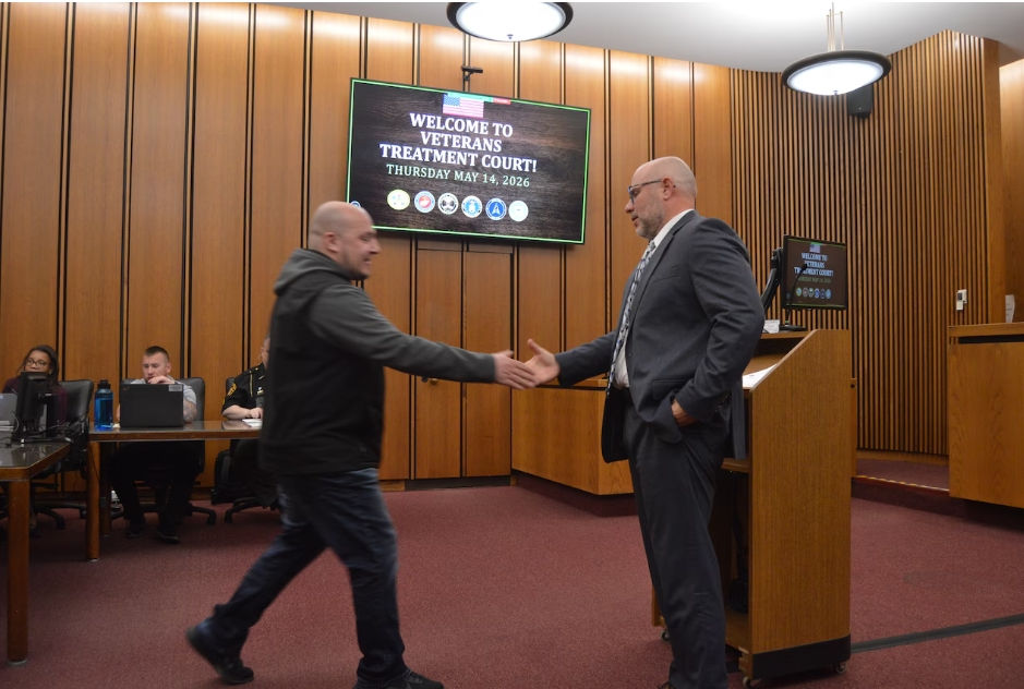 Nikita Prosin (left) shakes hands with Cuyahoga County Court of Common Pleas Judge Andrew Santoli during a May 14, 2026 session of Veterans Treatment Court.Lucas Daprile