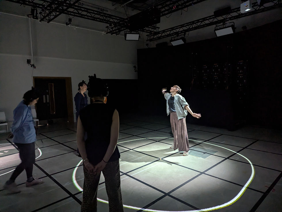 Person dancing in spotlight on grid floor, surrounded by onlookers in a dim room. Emotive pose with arms raised, creating a dynamic scene.