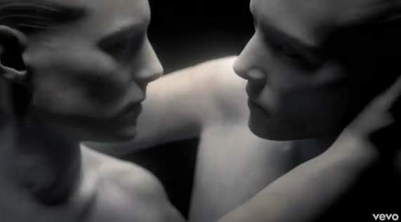 The clip presents a religious-looking marble statue that, once unveiled, comes to life and engages in a litany of sexual and violent vignettes. These reference mythology from Catholic, Roman and Greek literature — the Virgin Mary, Cupid and Psyche, Pluto and Proserpina, Michael and Lucifer, and Satyr and Hermaphroditus — as the track’s sparse, dramatic electronic backdrop supports Beth’s lyrics about kisses, murder and damnation.