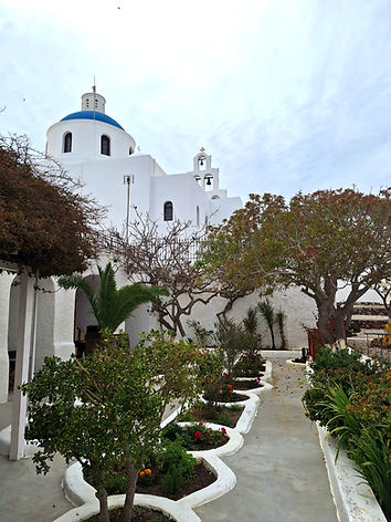 Garden view of the Domus K 1885 with The Virgin Mary of the Akathist Hymn Church in Oia Santorini