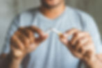 midsection-man-holding-broken-cigarette.jpg