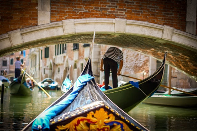 Gondolas rowing down a stream
